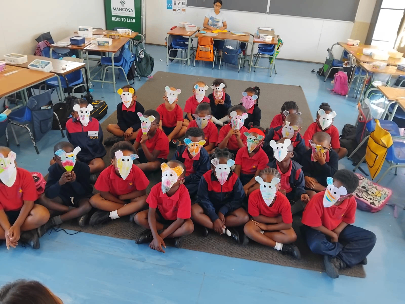 Children with hand-crafted story masks at a Cape Town primary school